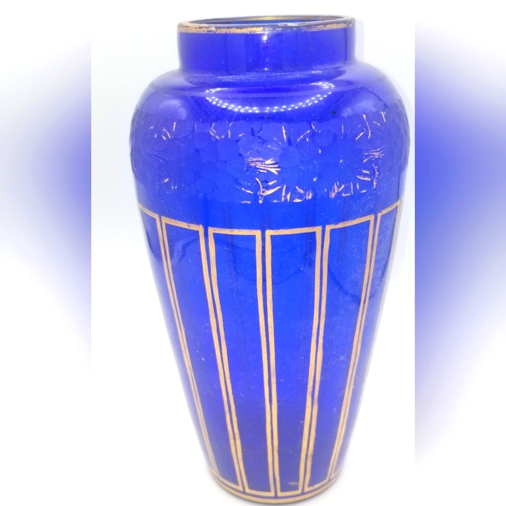 Blue Bohemian glass vase with gold trim and etched floral motif.